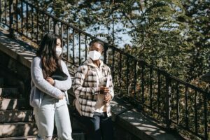 Women talking with masks on