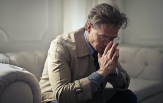 Man on sofa looking worried