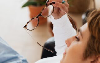 Worried woman reclining with glasses