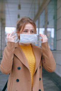 Woman putting on a mask