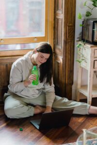 Content woman sitting on floor with laptop