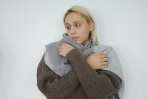 Anxious woman wearing sweater and wrap