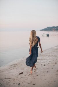 Blonde woman walking on beach