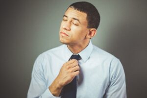 Man adjusting his tie