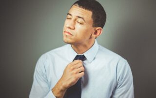 Man adjusting his tie