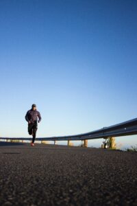 Man running on road in mountains