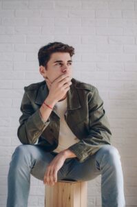 Pensive man Xsitting on wood box