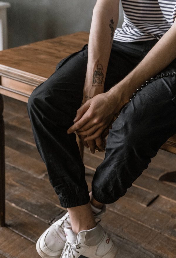 person sitting on table with hands and ankles crossed