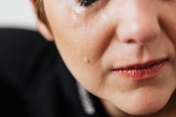 Woman with short hair in tears