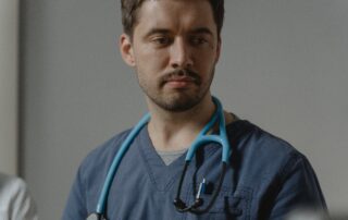 Man in Scrubs with Stethoscope Around Neck