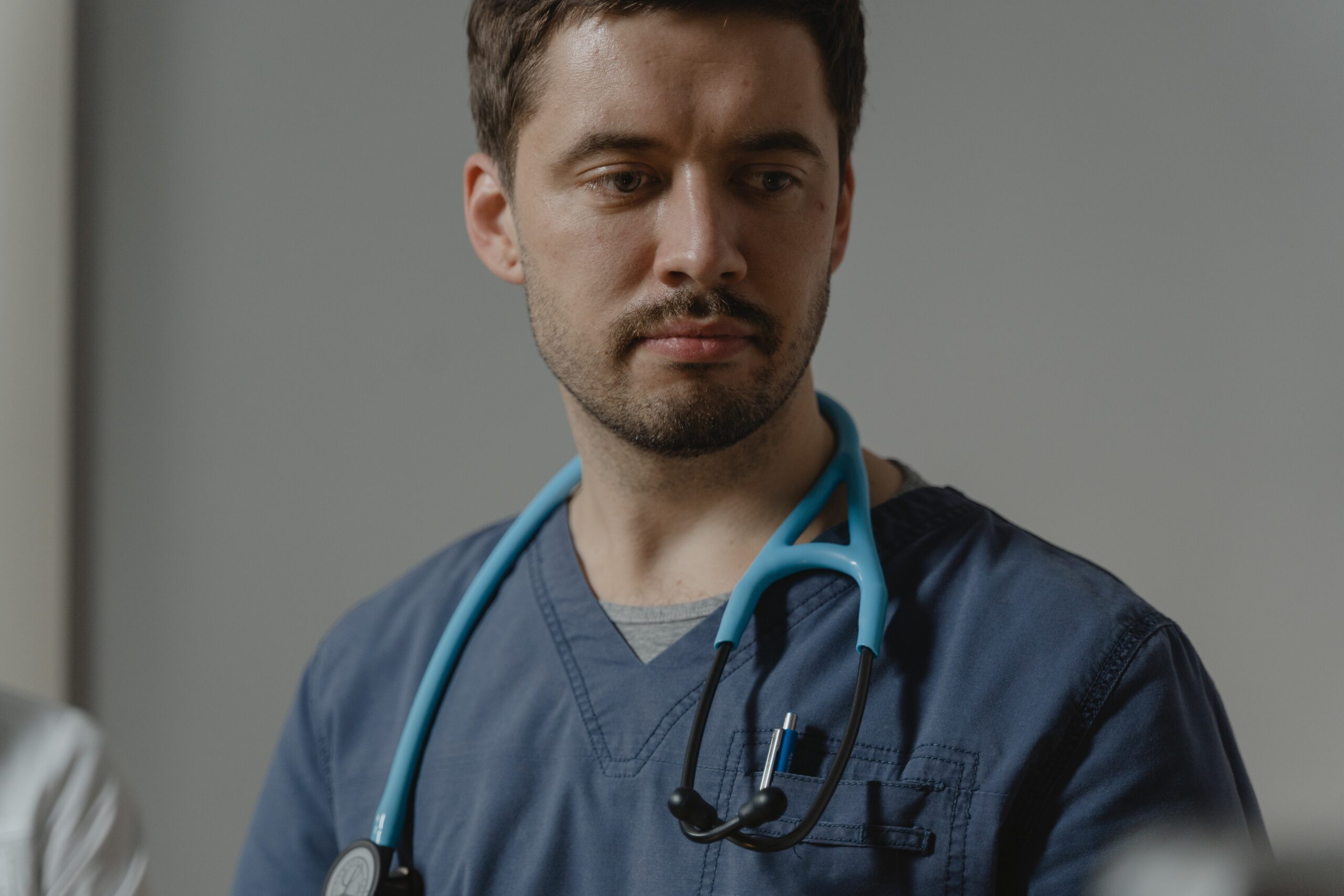 Man in Scrubs with Stethoscope Around Neck