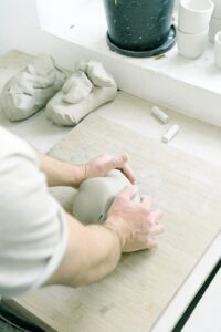 Person molding clay