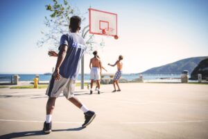 A group of men playing basketball outside