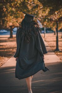 Woman in cap and gown from behind