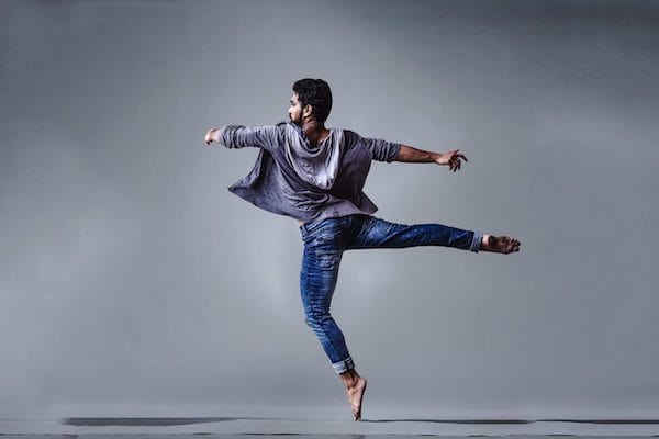 Man dancing in jeans and sweat jacket