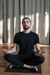 Man sitting on mat in meditation