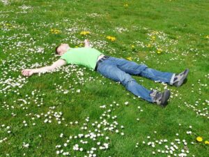 Man laying in field meditating