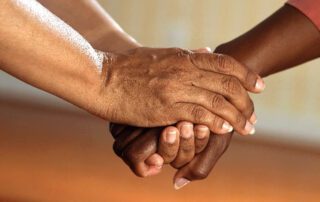 hands of two people clasping