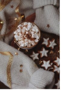 Holiday cocoa with marshmallows and a sweater