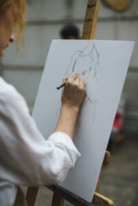Woman drawing on an easel