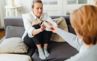 Woman receiving a tissue from another woman