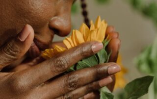 Woman smelling a yellow flower