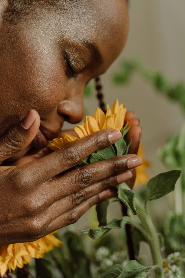 Woman smelling a yellow flower