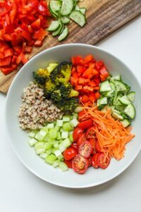 White bowl with veggies and quinoa