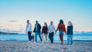 Group of people walking on a beach away from the water