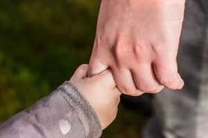 Holding hands - adult and child hands