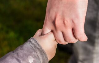 Holding hands - adult and child hands